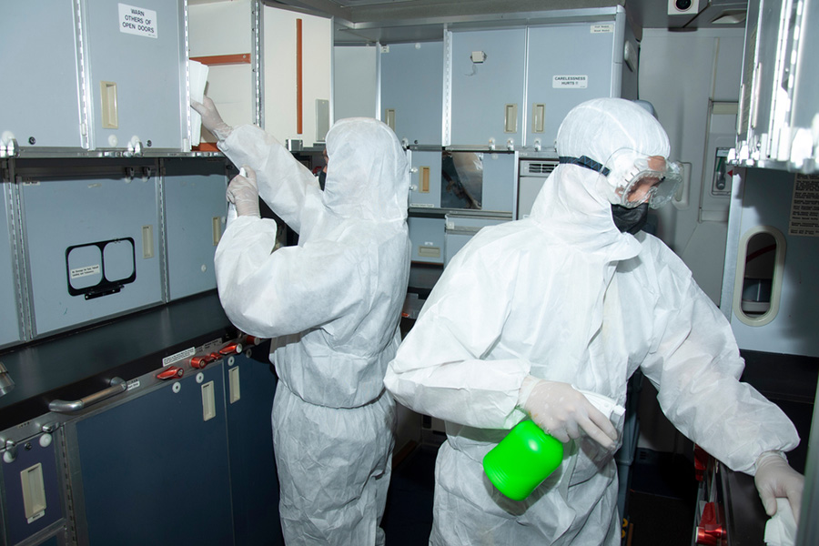 Two workers in full PPE carrying out covid-19 decontamination