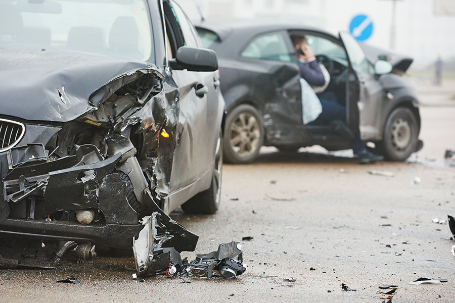 Two badly damaged cars that have been involved in a road traffic collision